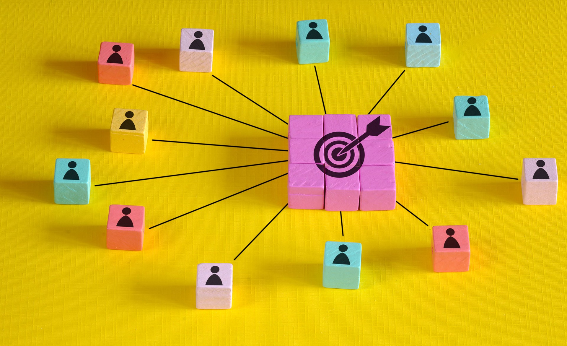 Customer relationship and teamwork concept. Multicolored wooden block with target icon linked with human icons. Team Goals, working together and customer service and care